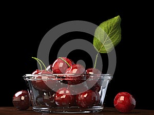 Fresh beautiful red cherries in a glass bowl