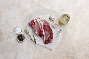 Fresh beef meat on white background with olive oil, herbs and spices