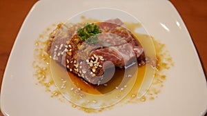 Fresh beef or pork meat steak with butter soy present in a white plate for grill or barbeque. Japanese Wagyu beef steak