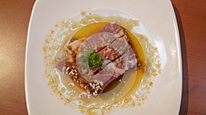 Fresh beef or pork meat steak with butter soy present in a white plate for grill or barbeque. Japanese Wagyu beef steak