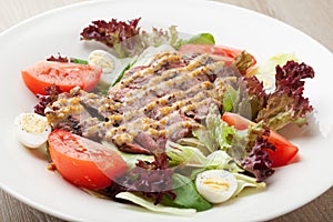 Fresh beef salad with lettuce, tomatoes, boiled eggs, mustard sa