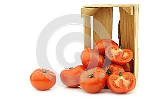 Fresh beef tomatoes and a cut one in a wooden crate