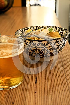 Beer and Spanish tapa on a bar counter photo