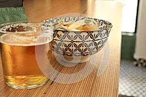 Beer and Spanish tapa on a bar counter photo