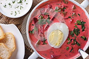 Fresh beet soup with egg close up. horizontal top view