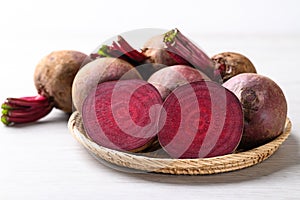 Fresh beetroot in natural basket on white background