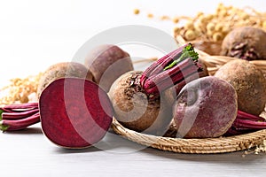 Fresh beetroot in natural basket on white background