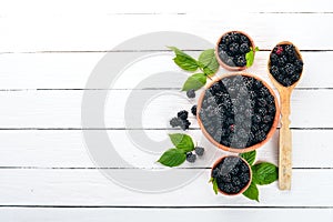 Fresh berries blackberries. On a black wooden background. Top view.