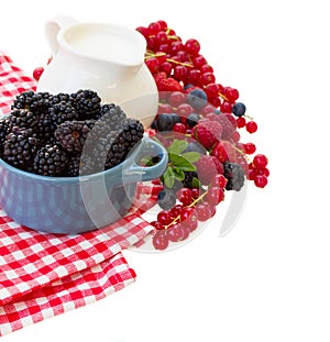 Fresh berries with jug of milk