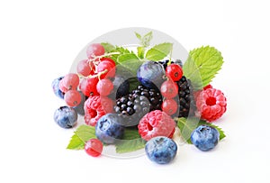 Fresh berries mix isolated on white background, top view. Strawberry, Raspberry, Red currant, Blueberry and Mint leaf