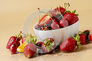 Fresh berries on peachbackground in the bowl