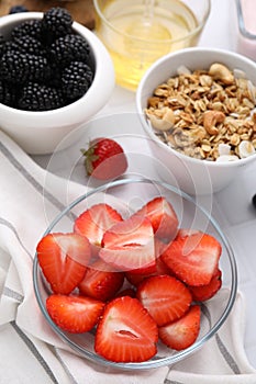 Fresh berries and tasty oatmeal on white tiled table. Healthy breakfast