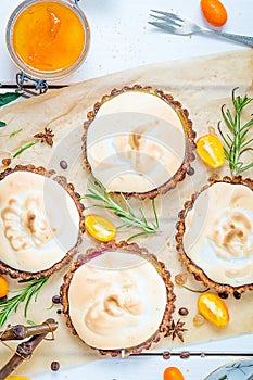 Fresh Berry Tartlets filled with Lemon Curd, Kumquat Jam, Berries and Meringue, Delicious Dessert