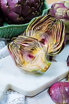 Fresh big Romanesco artichokes green-purple flower heads ready t