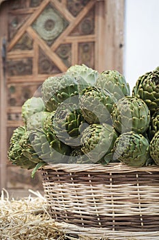 Background of fresh artichokes. Background of fresh artichokes. Fresh artichokes on display at the farmers` market for sale.