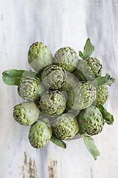 Background of fresh artichokes. Background of fresh artichokes. Fresh artichokes on display at the farmers` market for sale.