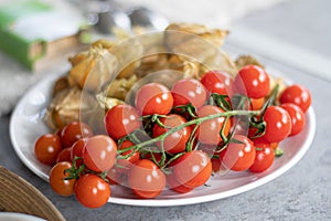 Fresh bio red ripe cherry tomatoes with ripe carambola, also known as star fruit