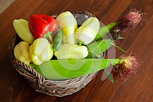 Fresh bio vegetables in a basket - red Californian pepper, eggplant, fresh corn, cob, yellow pepper, basket, kosh