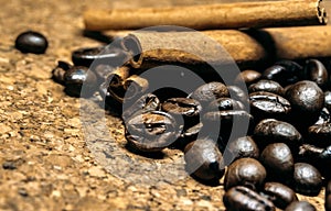 Fresh black coffe beans on cork table