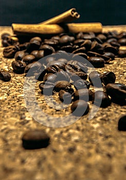 Fresh black coffe beans on cork table