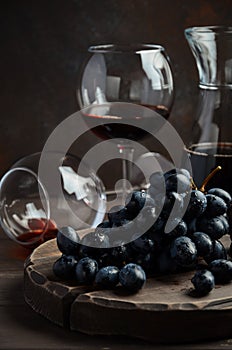 Fresh Black Grapes and Red Wine on Wooden Table