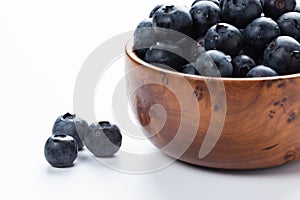 Fresh blue berries in a wooden cup