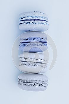 Fresh blue-colored macarons on a flat lay blue background. Shades of blue colors. French dessert photo