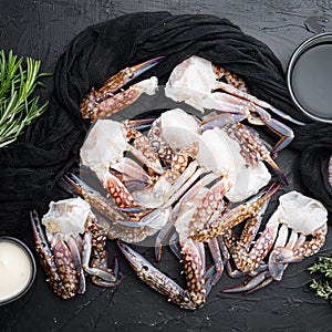 Fresh blue swimming crab Horse crab, Blue crab, Flower crab claws, on black background, top view flat lay