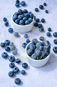 Fresh blueberries background with copy space. Blueberry antioxidant organic superfood in bowls concept for healthy