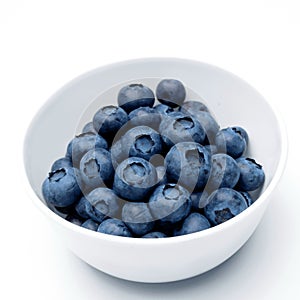 Fresh blueberries in bowl isolated on white. Top view.