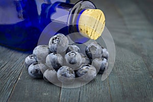Fresh blueberries and corked pharmacy bottle