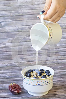 Fresh blueberries and figs corn flakes with milk