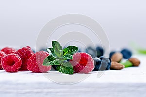 Fresh blueberries with mint on a wooden white table. Natural antioxidant. Concept of healthy food. Organic superfood