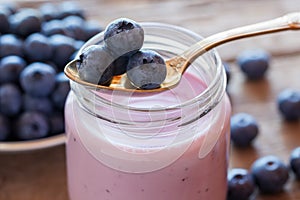 Fresh blueberries yogurt in glass jar