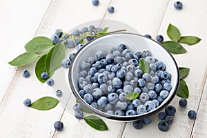 Fresh blueberry bowl on white wooden table