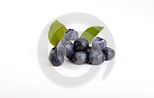 Fresh blueberry with green leaves isolated on white