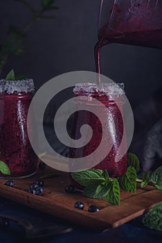 Fresh blueberry milkshake with mint herb