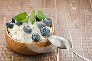 Fresh blueberry and mint with cottage cheese for healthy breakfast on a wooden background/Fresh blueberry and mint with cottage c