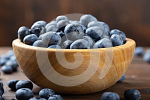 Fresh blueberry in wooden bowl. Concept of healthy and dieting eating