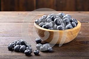 Fresh blueberry in wooden bowl. Concept of healthy and dieting eating