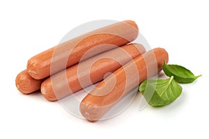 Fresh boiled sausages with basil, isolated on white background