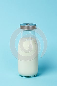 Fresh bottle of milk over blue background