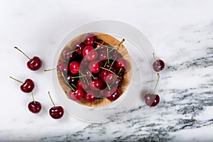 Fresh bowl of sweet red cherries on marble stone countertop