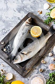 Fresh branzino fish with parsley, lemon and pink Himalayan salt