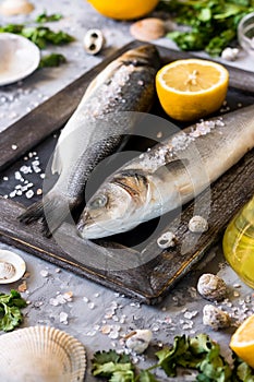 Fresh branzino fish with parsley, lemon and pink Himalayan salt