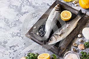 Fresh branzino fish with parsley, lemon and pink Himalayan salt