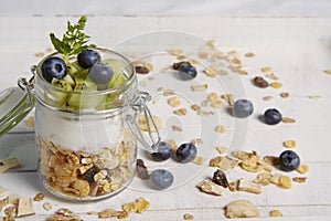 Fresh breackfast with cereals yogurt blueberry and kiwi photo