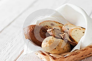 Fresh bread assortment, white wooden background