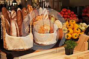 Fresh bread in a basket on the table. assortment of pastries on the table. bakery products