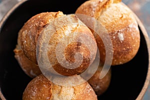 Fresh bread in a black bowl. Copy space. French bread. Fresh rolls.